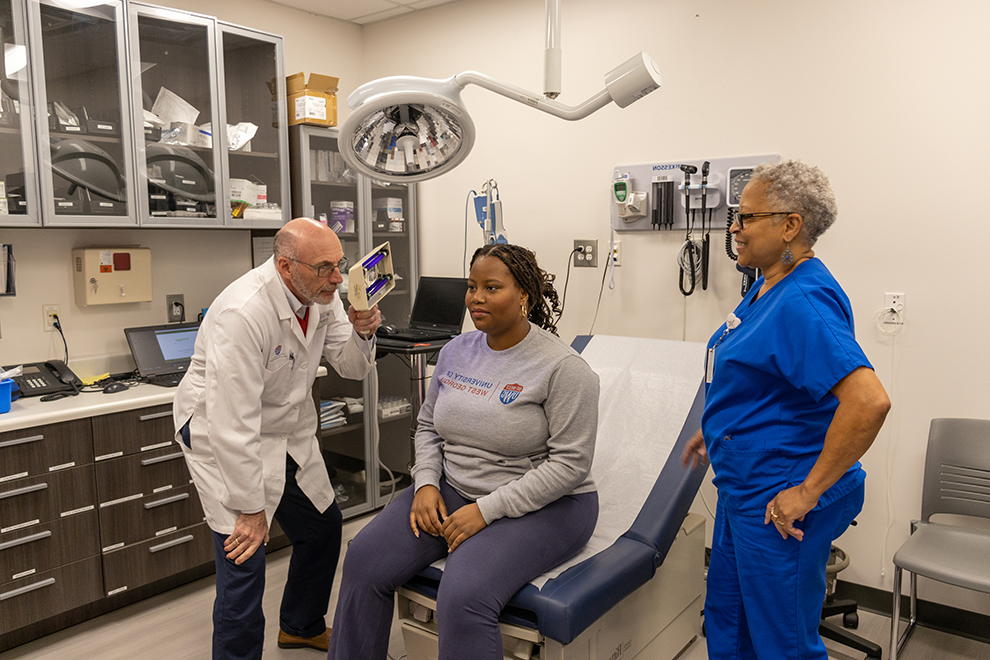 female student receiving medical care from a health services staff members